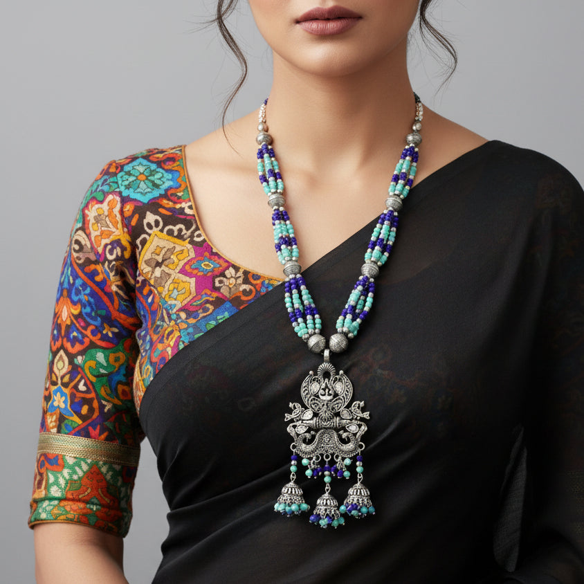 Necklace with decorative pendant and beaded chain on a dark background