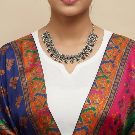 Silver necklace on a dark background