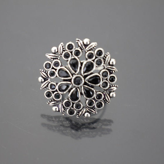 Silver floral ring on a gray background