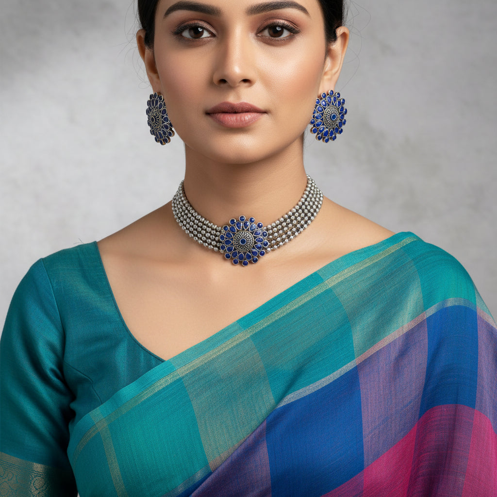 Jewelry set with blue and silver design on a gray background, featuring the brand 'Saheli'.