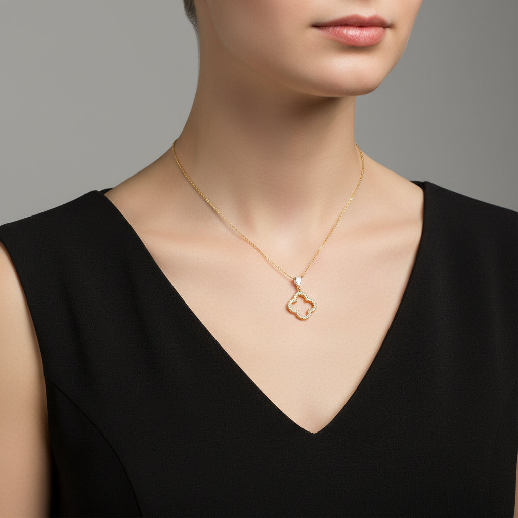 Gold necklace with a heart-shaped pendant on a branded card