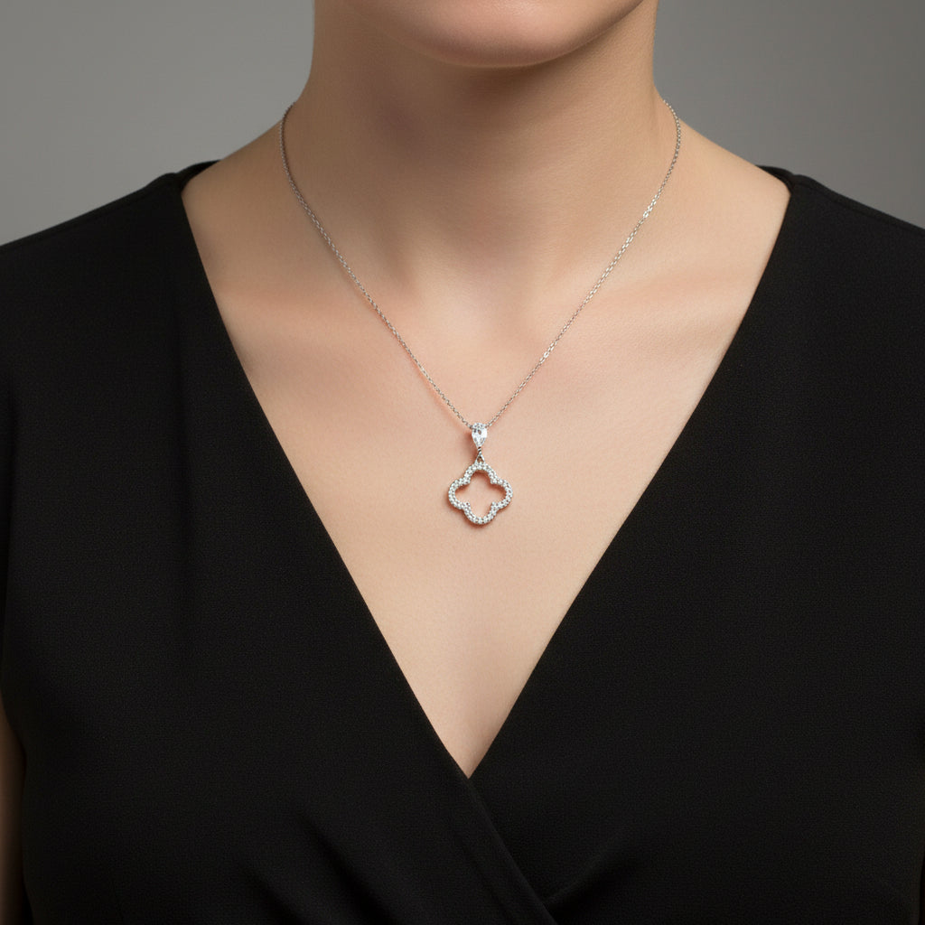 Heart-shaped pendant necklace on a Saheli branded card against a dark background