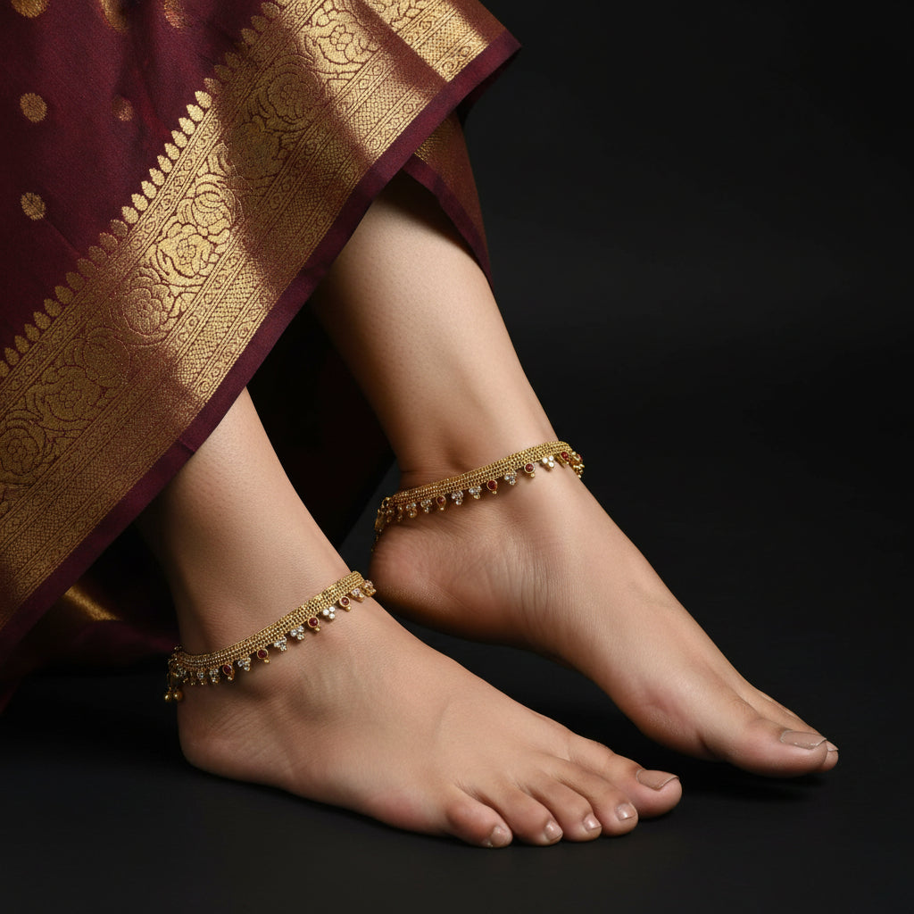 Gold necklace with red and white stones on a dark background, featuring the brand 'Saheli'.