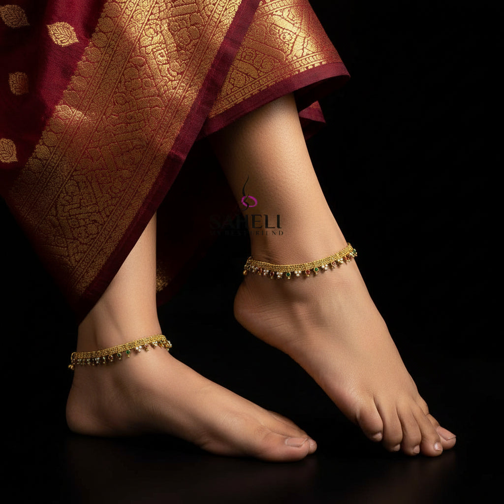 Gold necklace with colorful stones on a dark background, featuring the brand 'SAHELI'.
