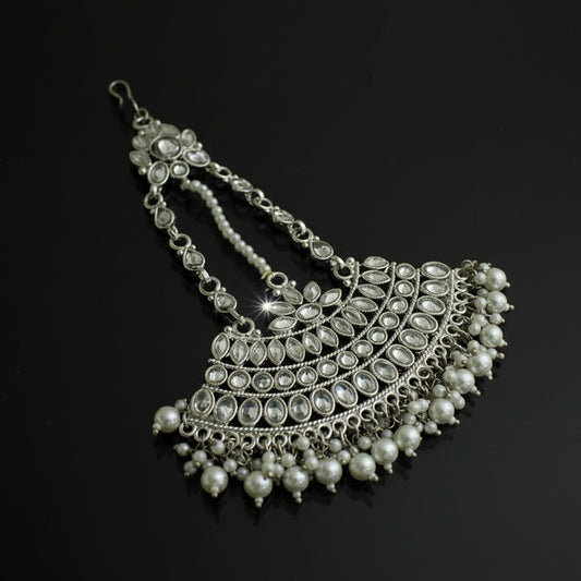 Silver necklace with pearls on a black background