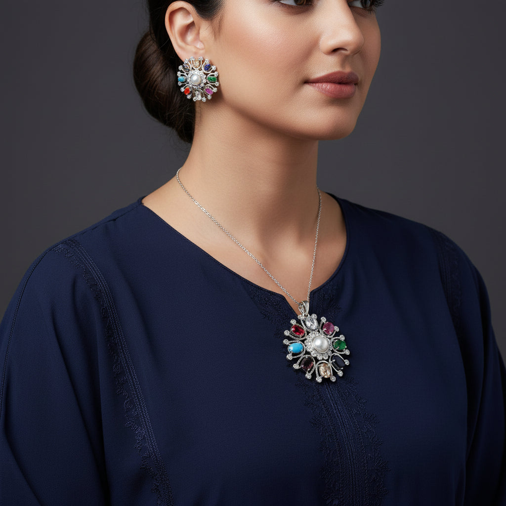 Three silver pendants with colorful gemstones on a dark background