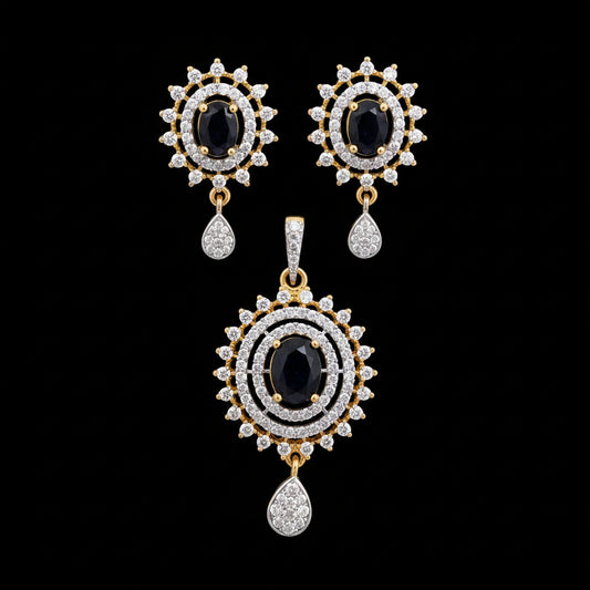 Ornate earrings with black gemstones and gold accents on a gray surface, branded 'SAHELI'.