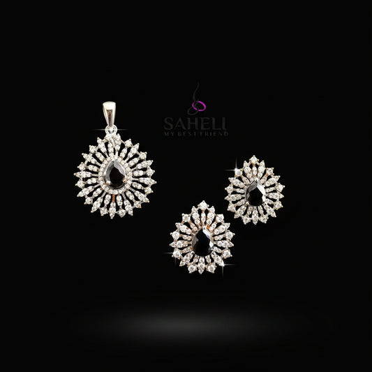 Set of silver earrings with black stones on a gray background, featuring the brand 'Saheli'.