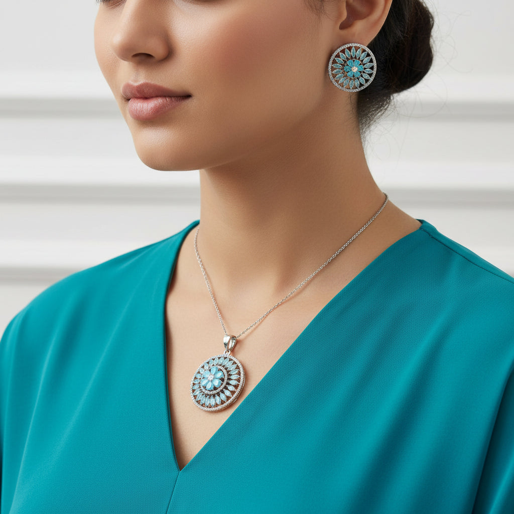 Jewelry set with circular pendants featuring blue gemstones on a dark background