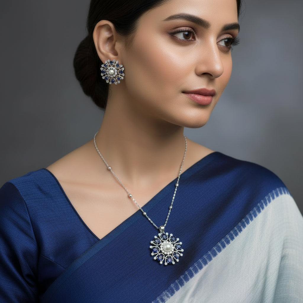 Jewelry set with floral designs featuring pearls and blue stones on a dark background
