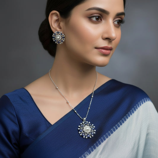 Jewelry set with floral designs featuring pearls and blue stones on a dark background