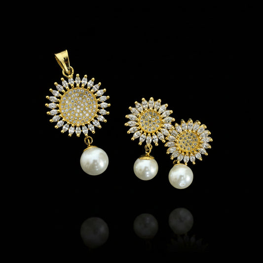 Gold and pearl earrings on a dark surface with 'SAHELI' branding.