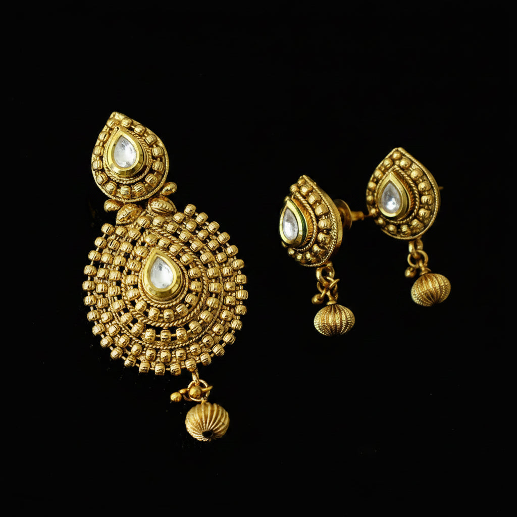 Gold earrings with intricate designs on a black background, featuring the brand 'Saheli'.