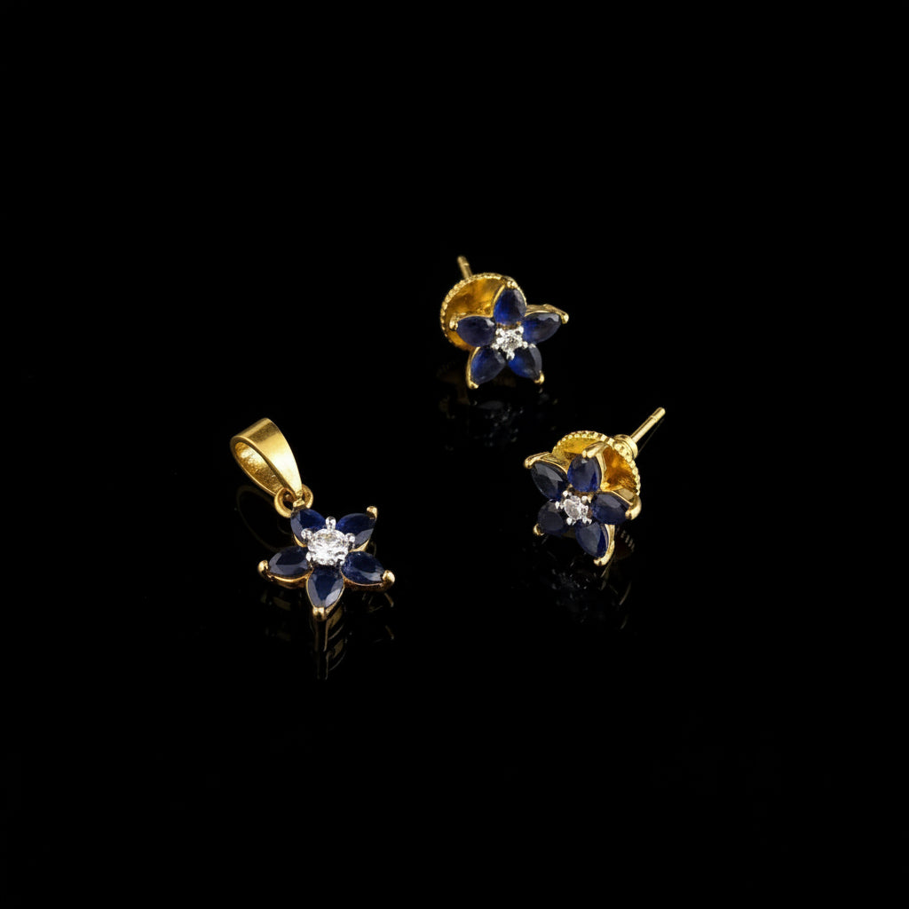Gold and blue butterfly-shaped earrings on a gray background with 'SAHELL' branding.