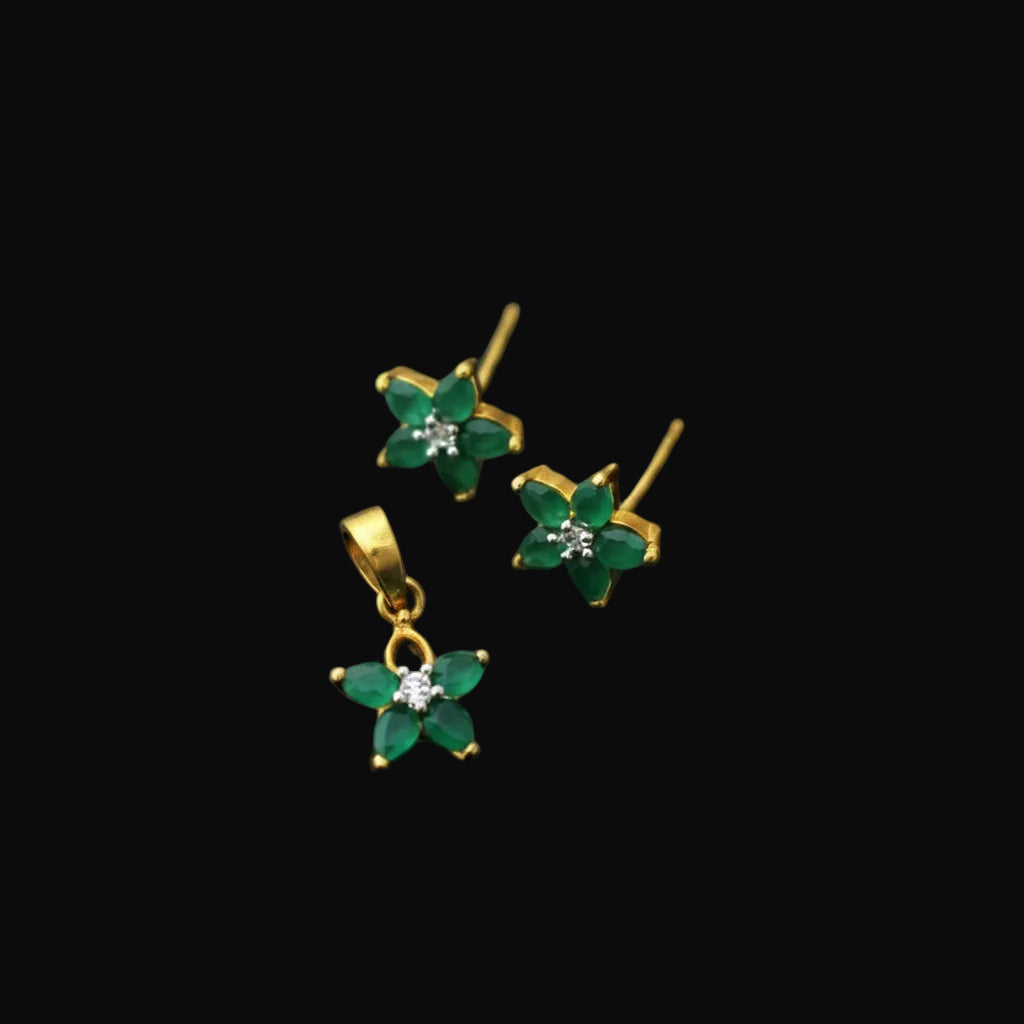 Gold and green floral earrings with a 'SAHELI' tag on a gray background