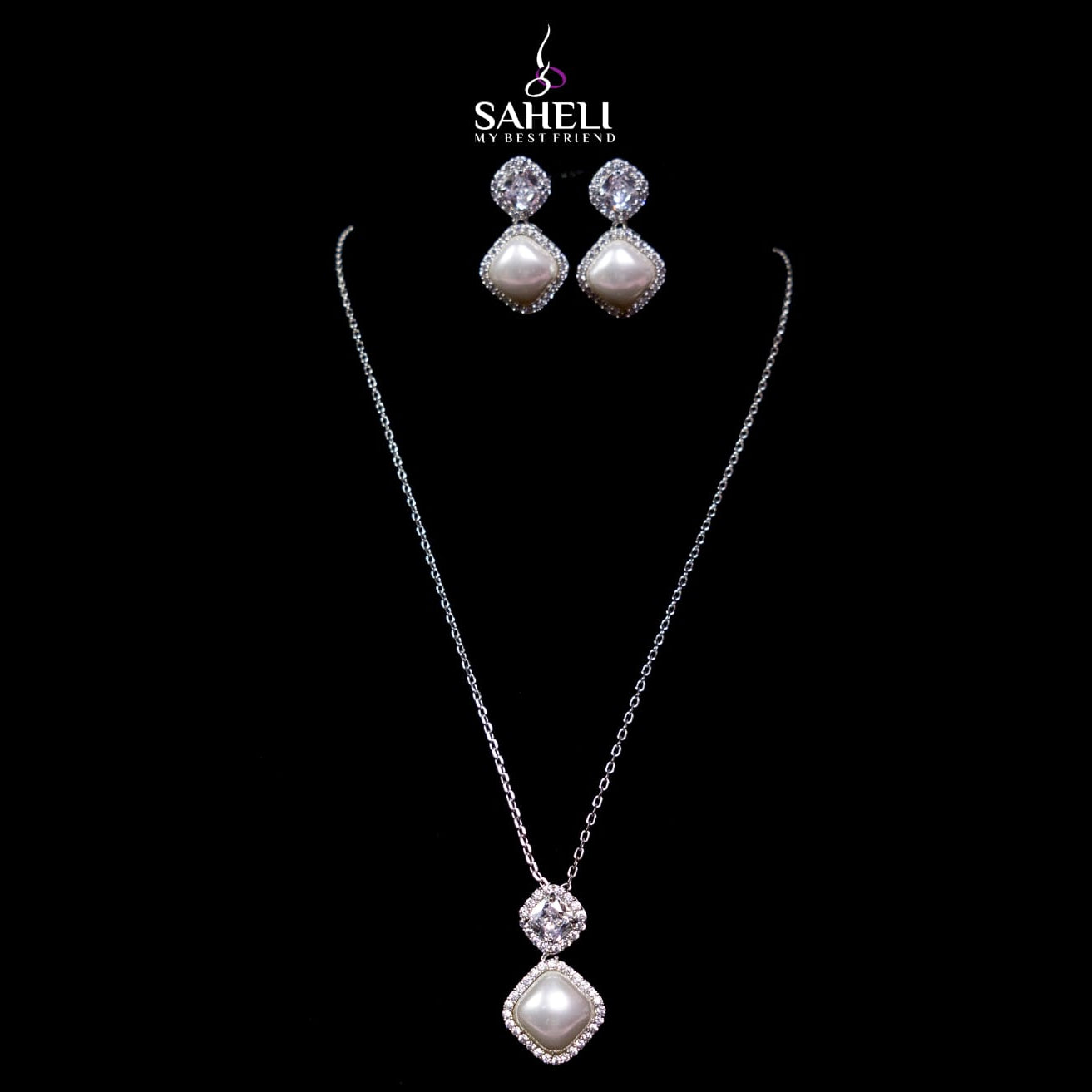 Jewelry set with necklace and earrings on a black background, featuring the brand 'Saheli'.