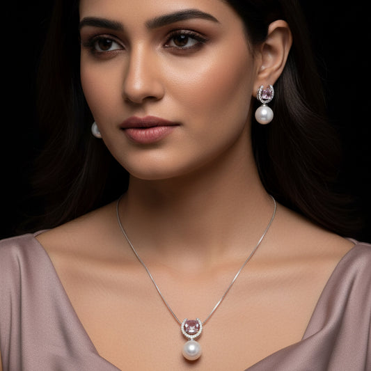 Jewelry set with necklace and earrings featuring pearls and purple gemstones on a black background.