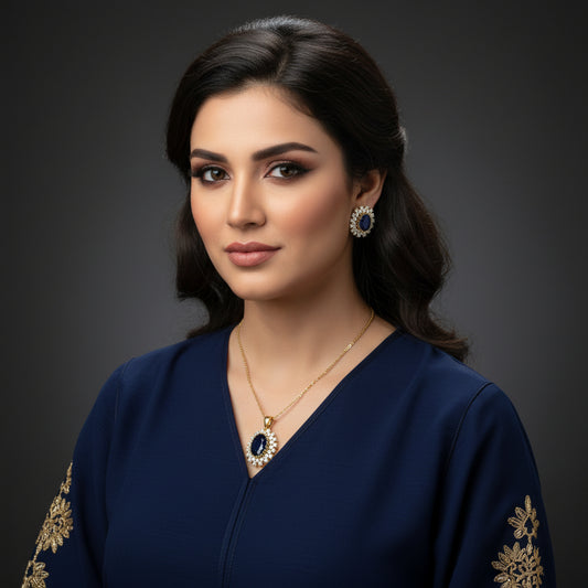 Pair of earrings with blue gemstones and gold accents on a gray background, branded 'Saheli'.