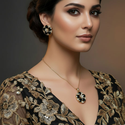 Gold and gray floral earrings on a dark surface with 'Saheli' branding.