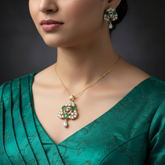 Ornate earrings with green gemstones and gold accents on a dark background, branded 'Saheli'.