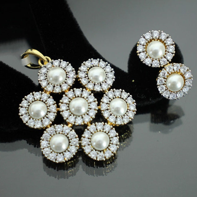 Pair of pearl and diamond earrings on a dark background with 'SAHELI' branding.