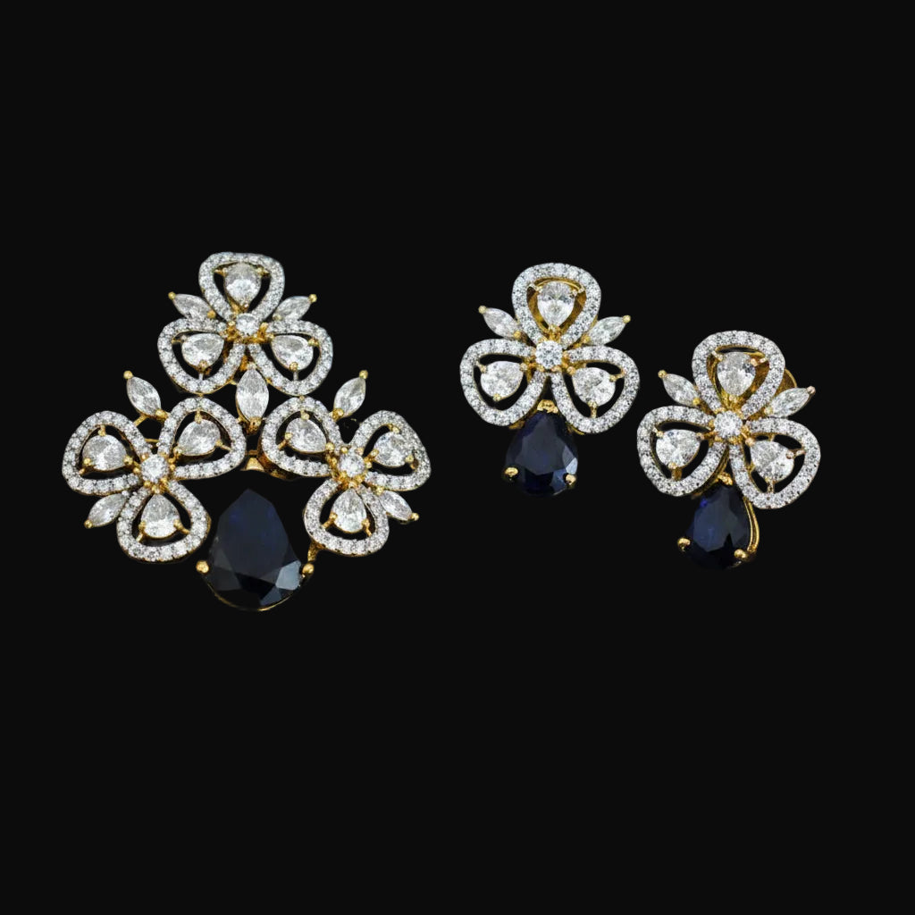 Pair of diamond earrings with black stones on a dark background, featuring the brand 'SAHELI'.