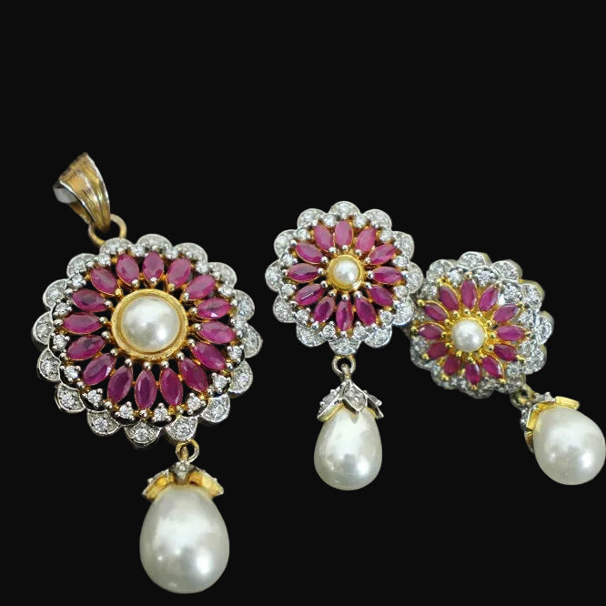 Ornate earrings with floral design and pearl drops on a dark background, branded 'Saheeli'.