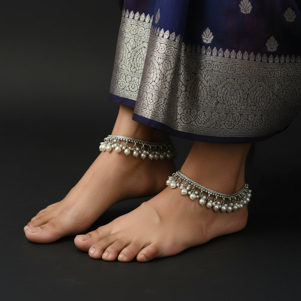 Silver bracelet with pearl-like beads on a dark background