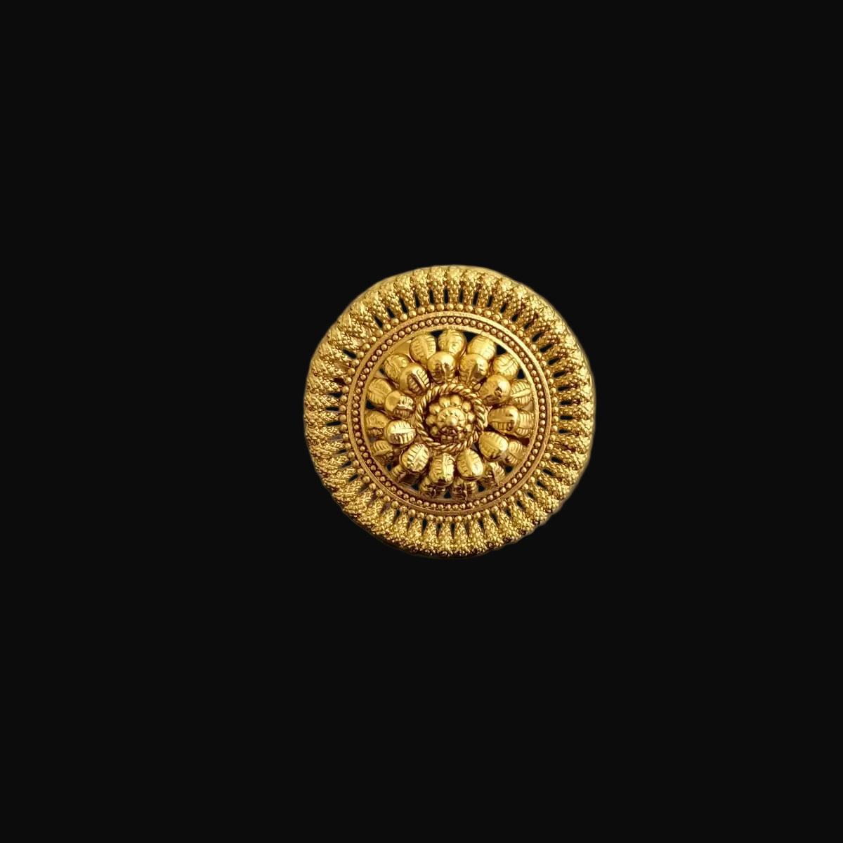 Gold ring with intricate design on a dark gray background