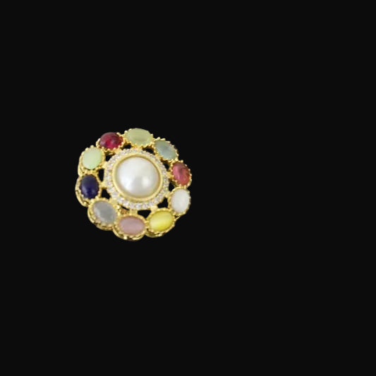 Multicolored gemstone ring on a black mannequin hand against a dark background