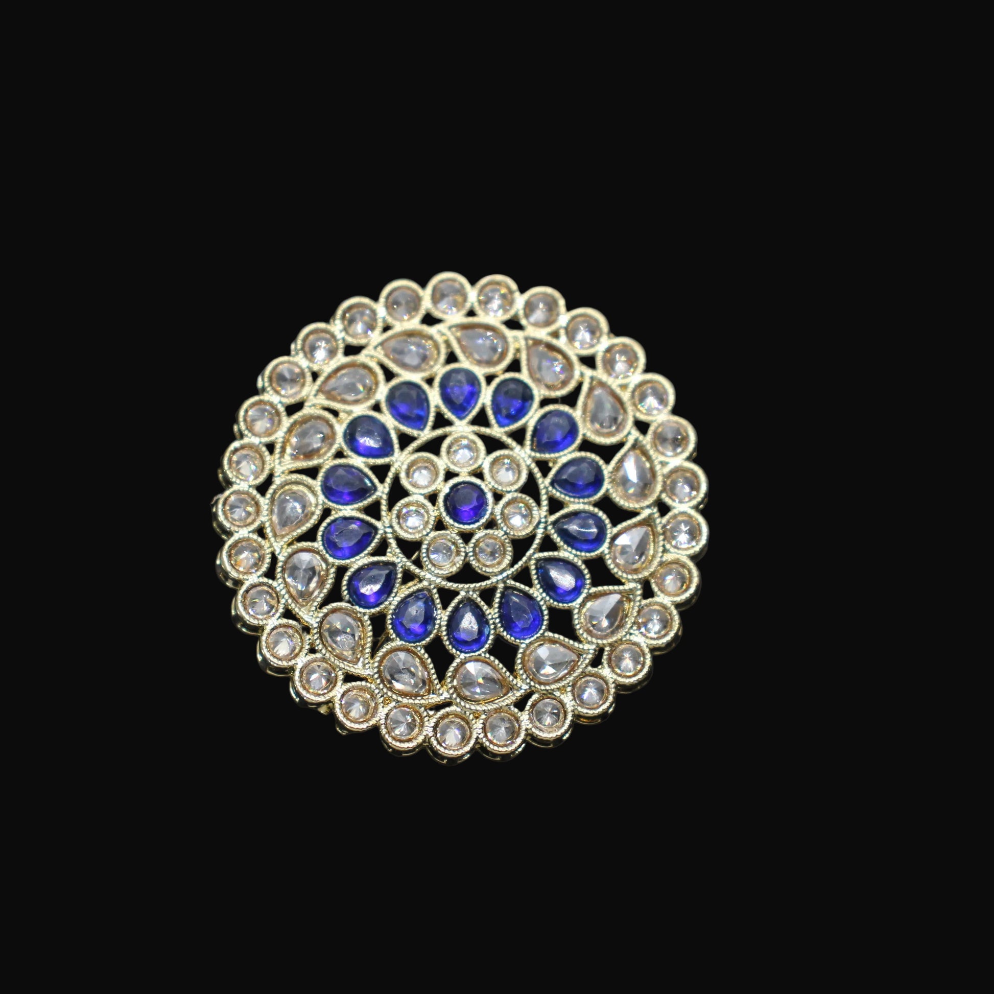 Jewelry ring with blue and clear gemstones on a black mannequin hand