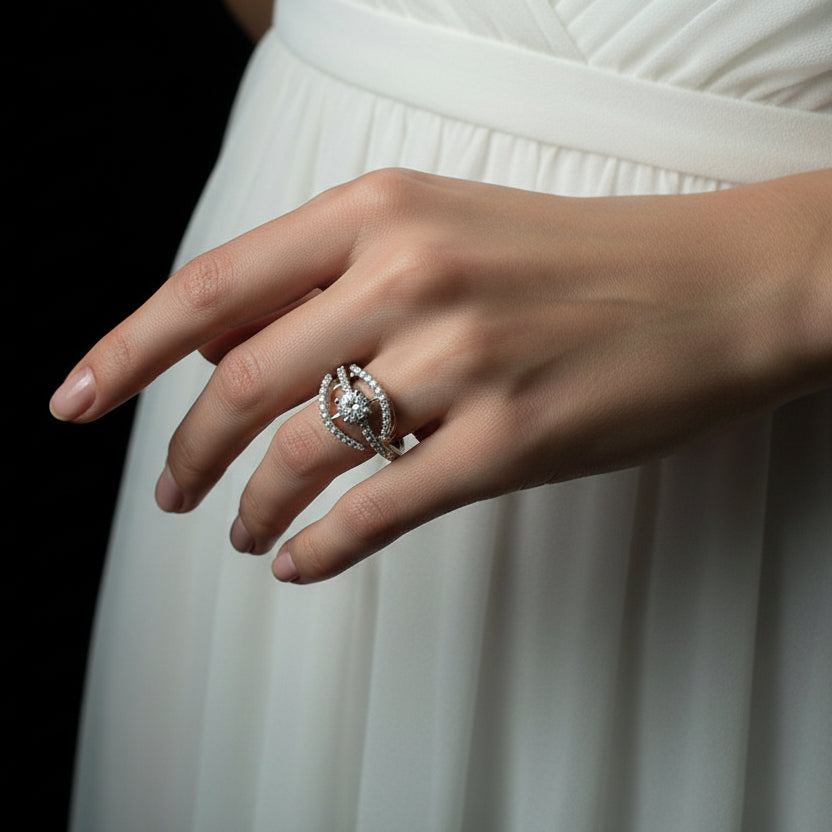 Silver ring with a diamond on a dark surface, branded 'Saheli'.