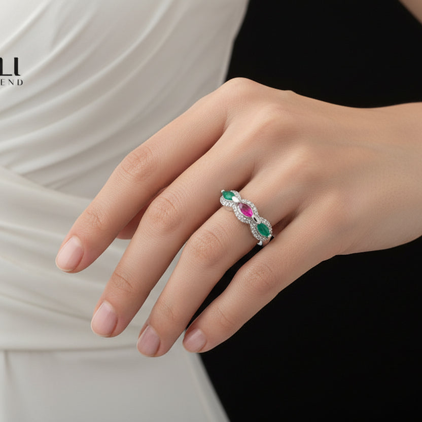 Silver necklace with colored stones on a black mannequin hand, branded 'Saheli'.