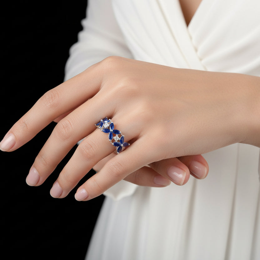 Blue and silver ring on a mannequin hand with 'SAHELI' branding.