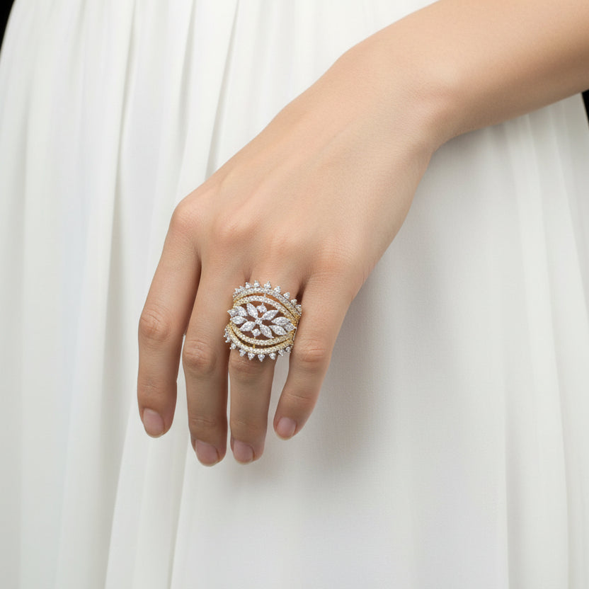 Jewelry ring with diamonds on a gray background, featuring the brand 'Saheli'.