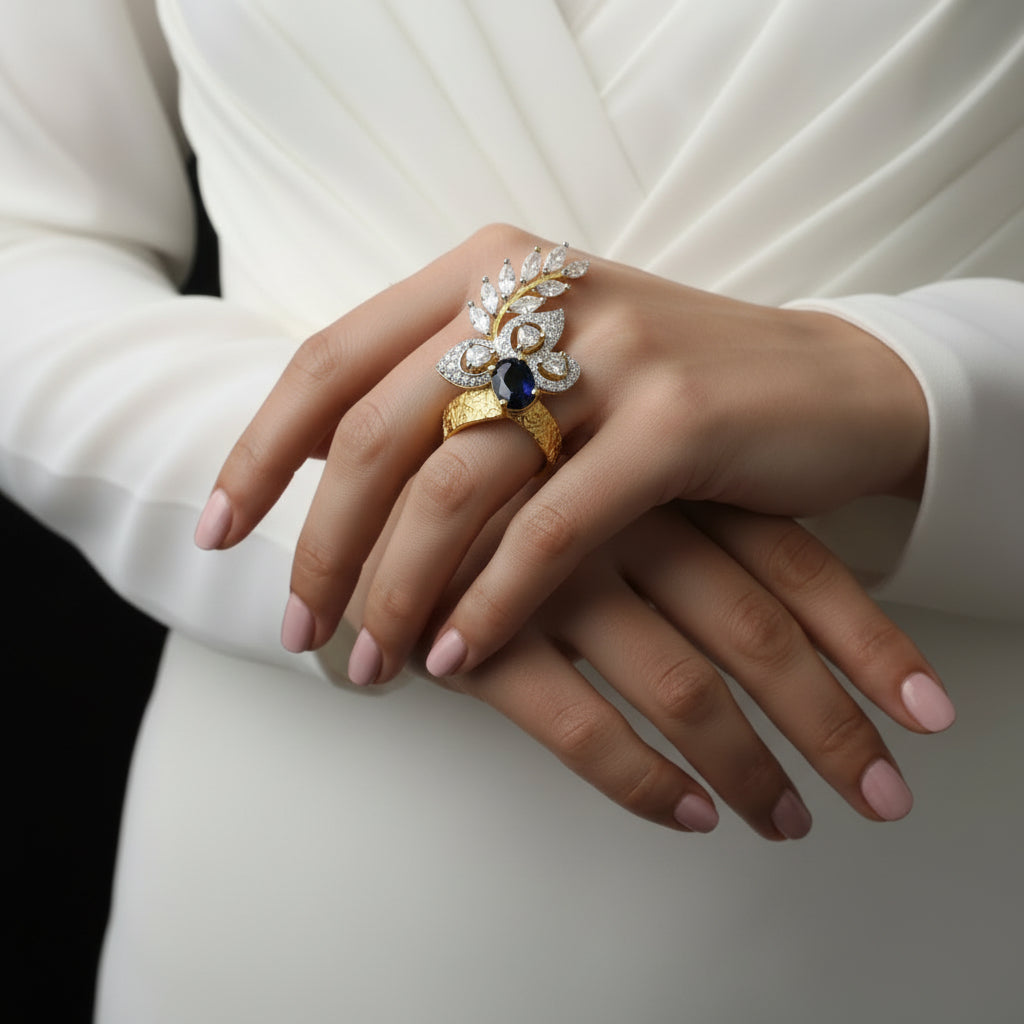 Gold ring with a blue gemstone on a gray background, featuring the brand 'Saheli My Best Friend'.
