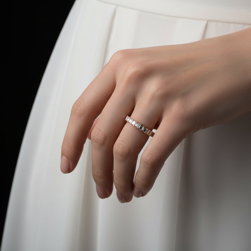 Diamond ring on a black mannequin hand against a dark background