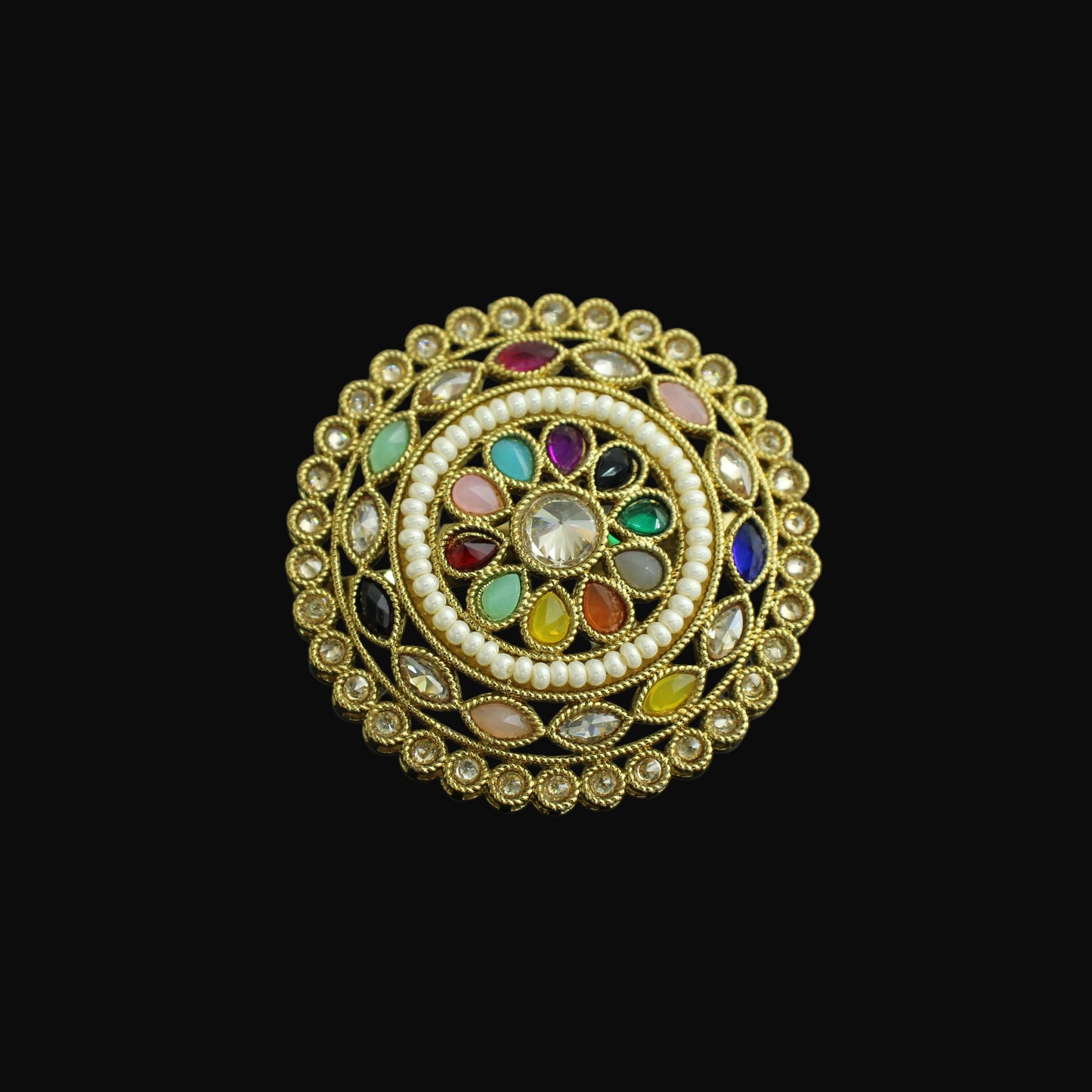 Decorative ring with colorful gemstones on a dark background