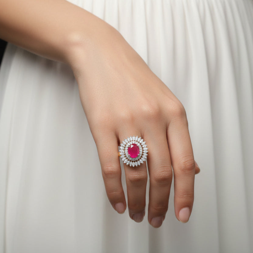 Silver ring with a red gemstone on a gray background, featuring the brand 'Saheli'.