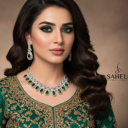 Jewelry set with necklace and earrings featuring green gemstones on a dark background, branded 'Saheli'.