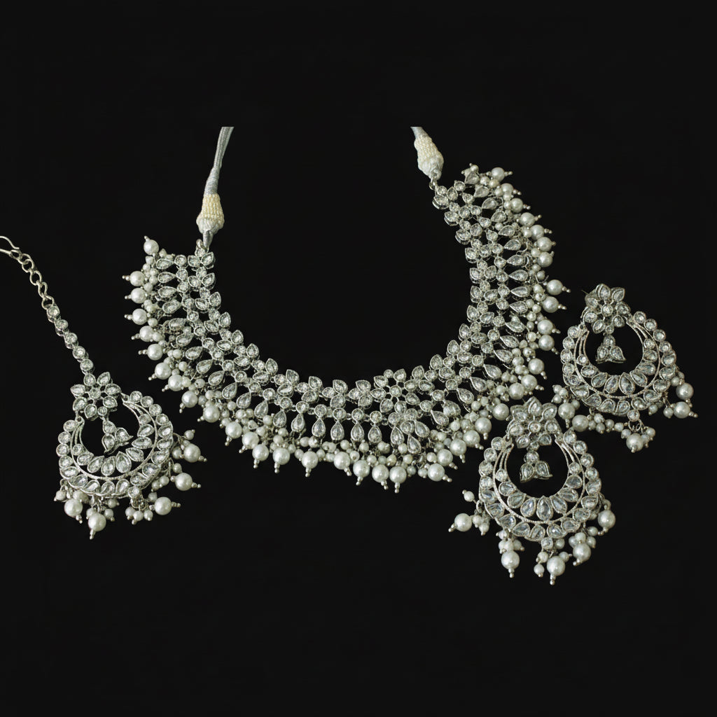 Silver necklace with pendant on a black background, featuring the brand 'Saheli'.