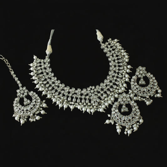 Silver necklace with pendant on a black background, featuring the brand 'Saheli'.