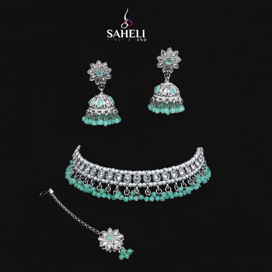 Jewelry set with choker, earrings, and necklace on a black stand with 'SAHELI' branding.