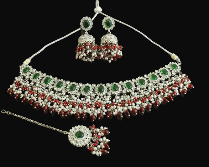 Jewelry set with necklace, earrings, and ring on a dark background