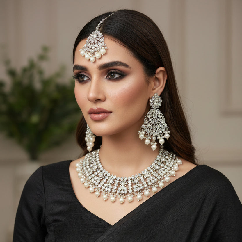 Silver necklace set with pendants on a dark background