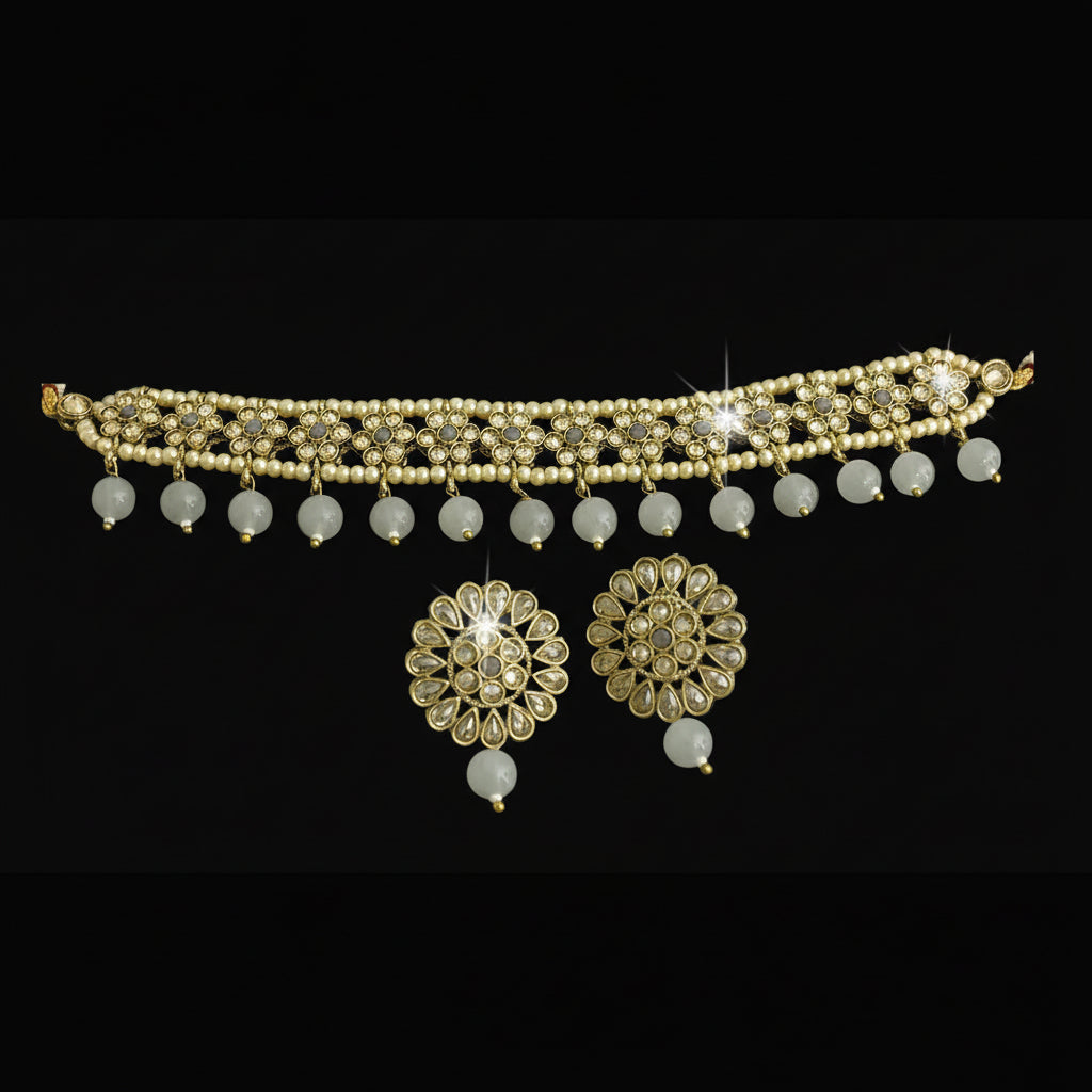 Gold necklace with beads and floral pendants on a dark background