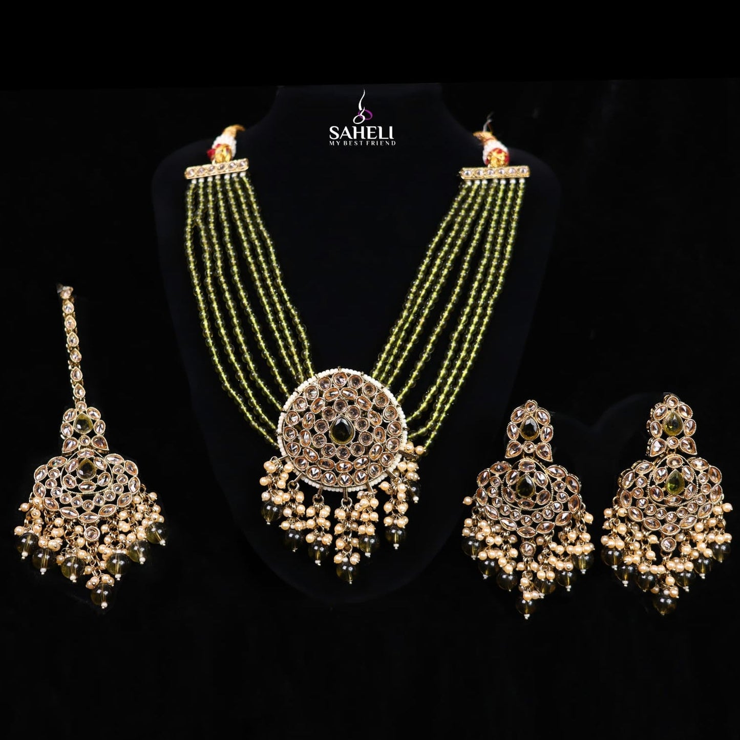 Jewelry set with necklace, earrings, and choker on a black background with 'Saheli' branding.