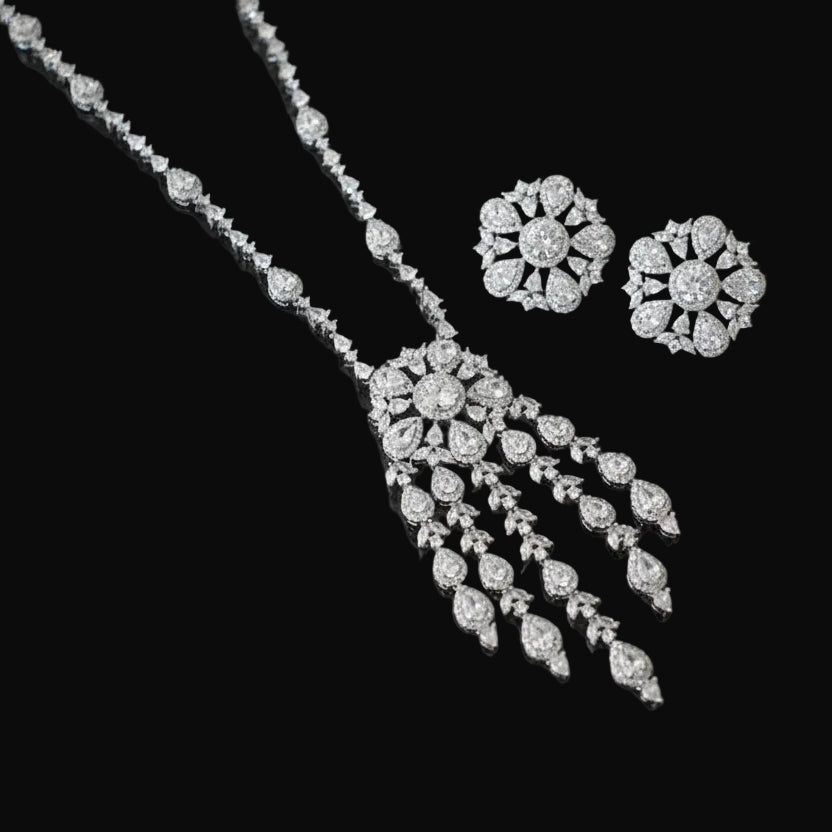 Diamond necklace and earrings on a black background