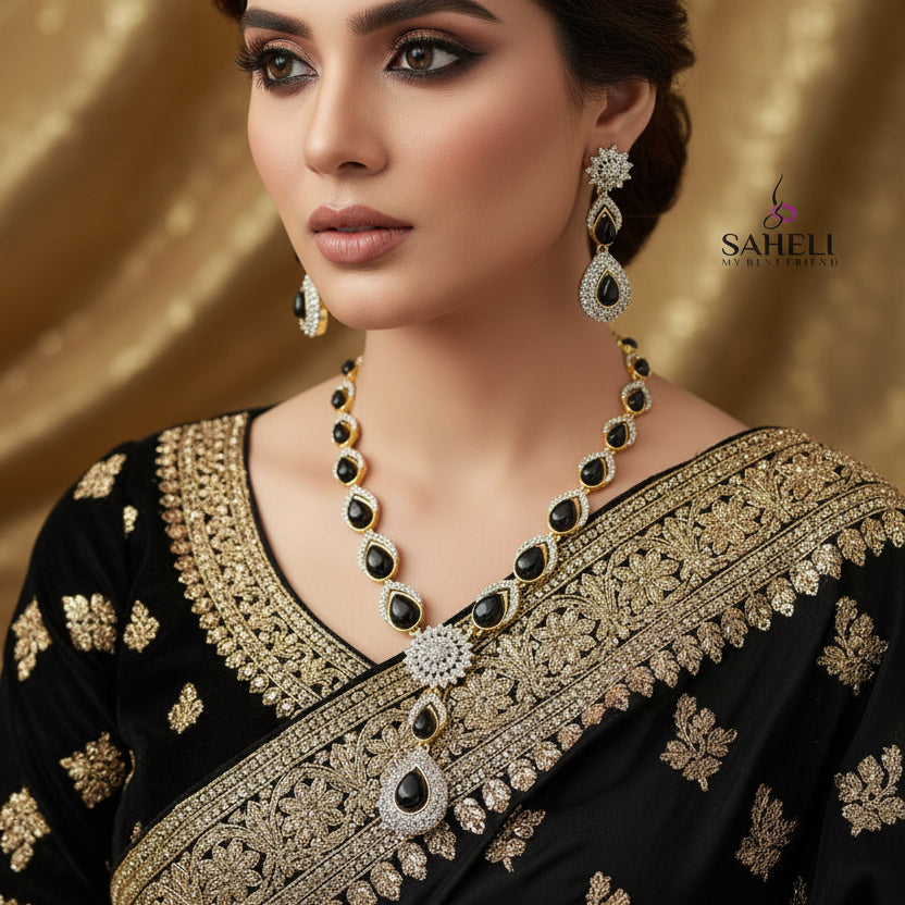 Jewelry set with necklace and earrings on a dark background, featuring the brand 'Saheli'.