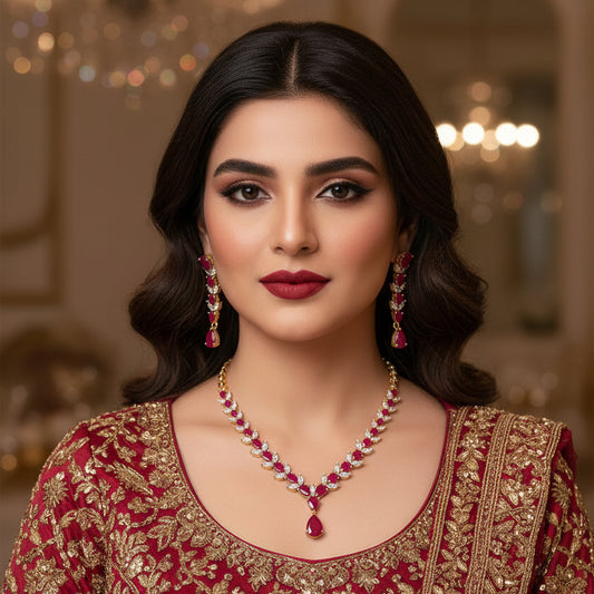 Jewelry set with necklace and earrings featuring red stones on a dark background, branded 'Saheli'.